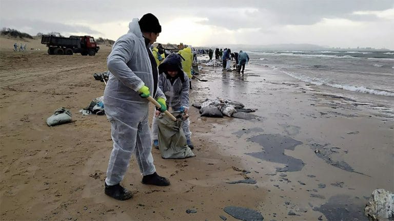 voluntários russos limpam praia atingida por petróleo 